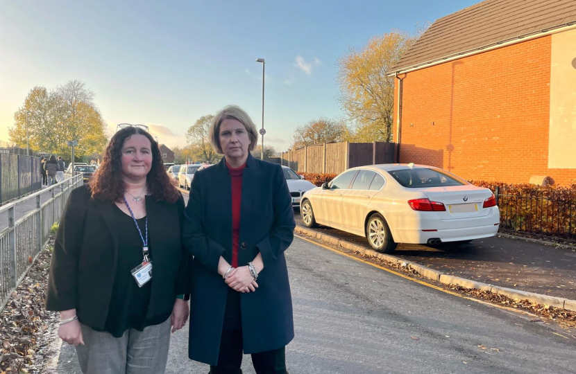 Katherine Fletcher and the headteacher of St. Mary's outside the school, bad parking visible