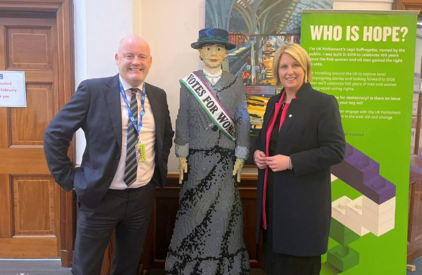 Katherine Fletcher stood with the vice principal of Cardinal Newman College and a Lego model of a suffragette.