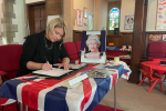 Katherine Fletcher signing a book of condolences.