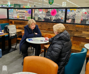 Katherine Fletcher sat in a Morrisons Café, talking to a constituent