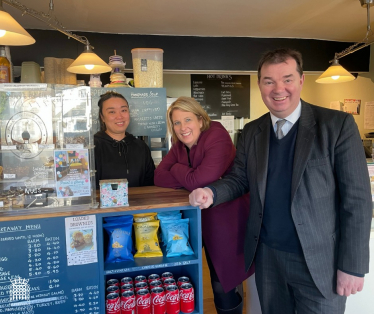 Katherine Fletcher with Guy Opperman and a member of staff in a small café.